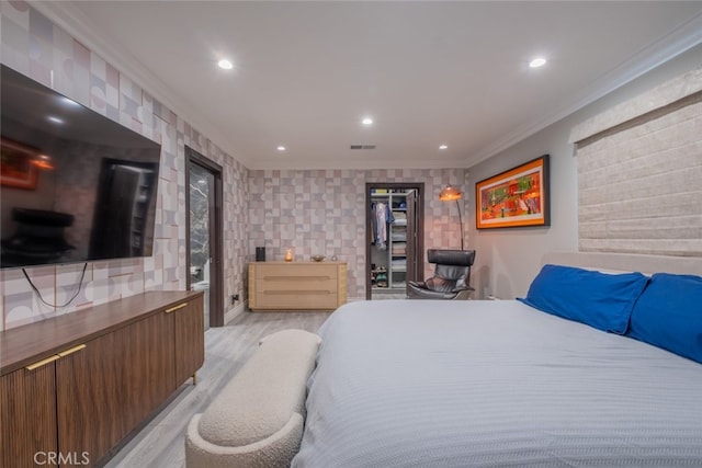 bedroom with crown molding and light hardwood / wood-style flooring