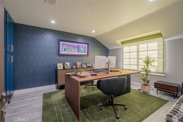 home office featuring vaulted ceiling and hardwood / wood-style floors