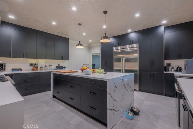 kitchen featuring decorative light fixtures, a center island, appliances with stainless steel finishes, ornamental molding, and light tile patterned floors