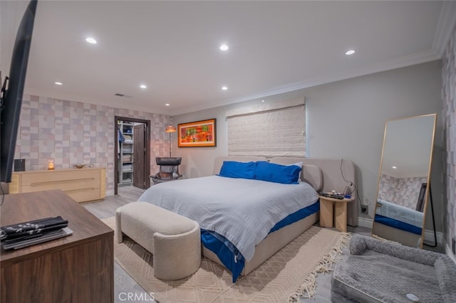 bedroom featuring light wood-type flooring and crown molding