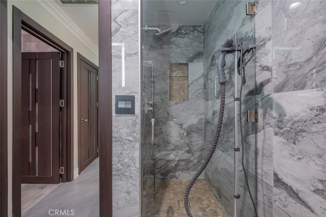 bathroom featuring ornamental molding and a shower with shower door