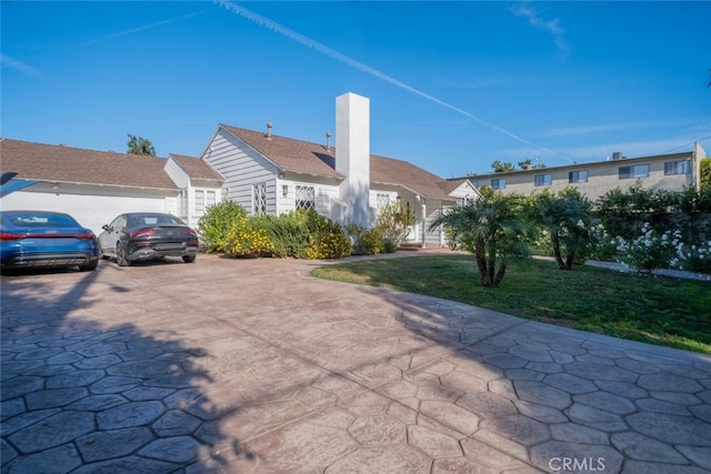 exterior space with a front yard and a garage