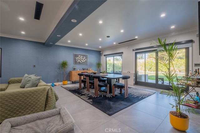 dining space with ornamental molding and plenty of natural light