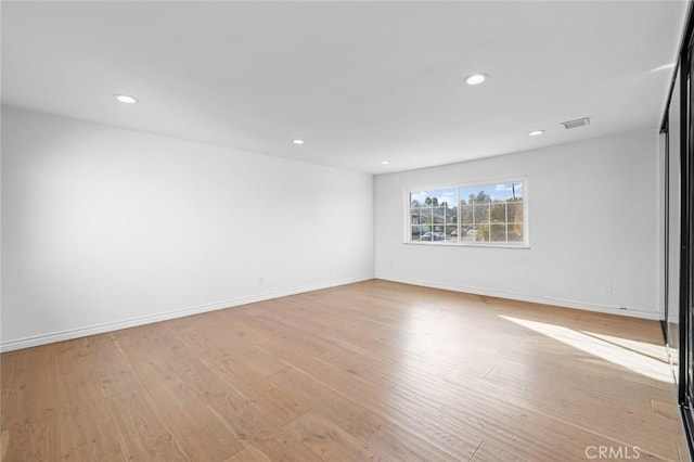 unfurnished room with light wood-type flooring