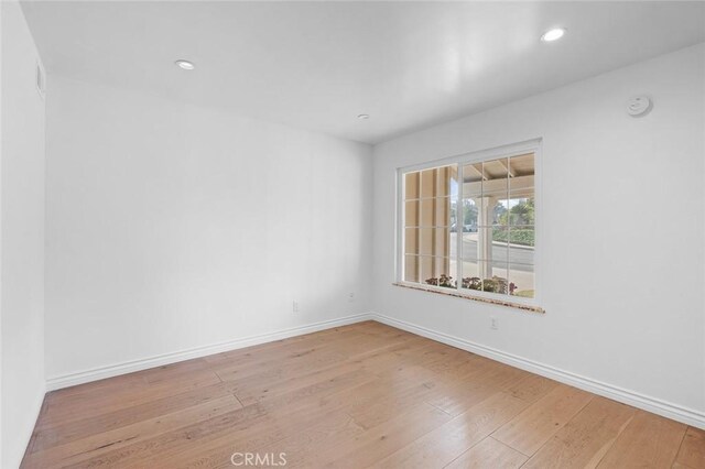 unfurnished room with light hardwood / wood-style flooring