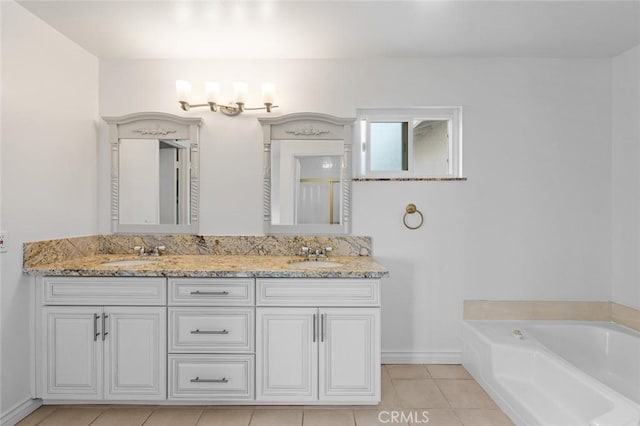 bathroom with a bath, tile patterned floors, and vanity