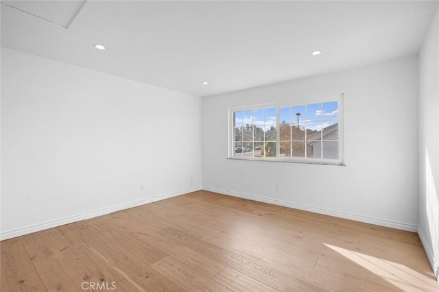 unfurnished room with light wood-type flooring