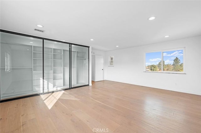 spare room featuring light wood-type flooring