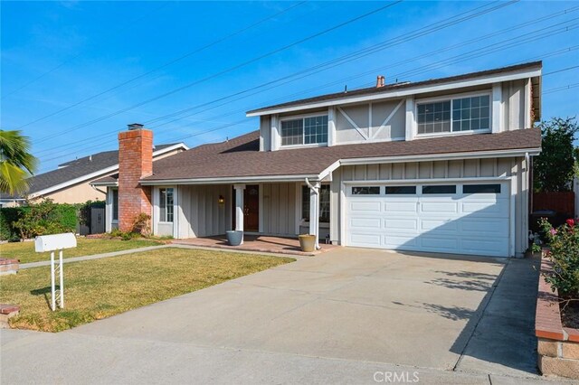 view of property with a front yard and a garage