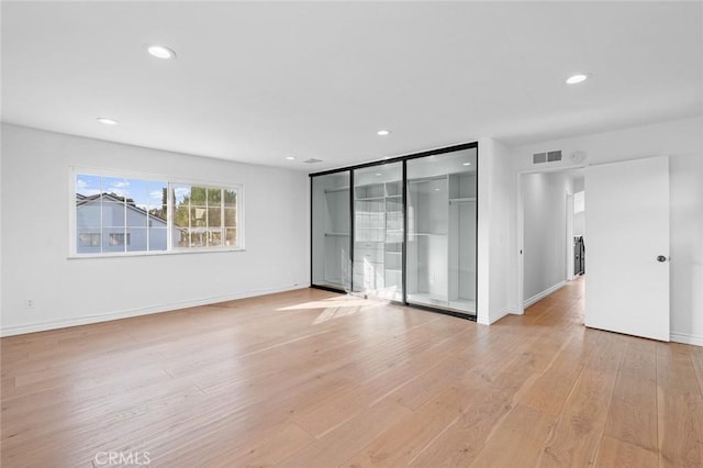 empty room with light wood-type flooring