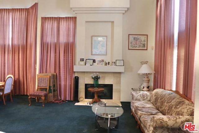 sitting room featuring carpet and a tiled fireplace