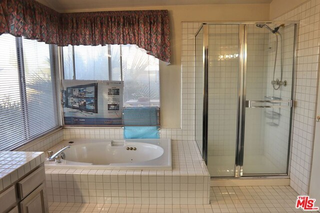 bathroom featuring separate shower and tub, vanity, and tile patterned floors