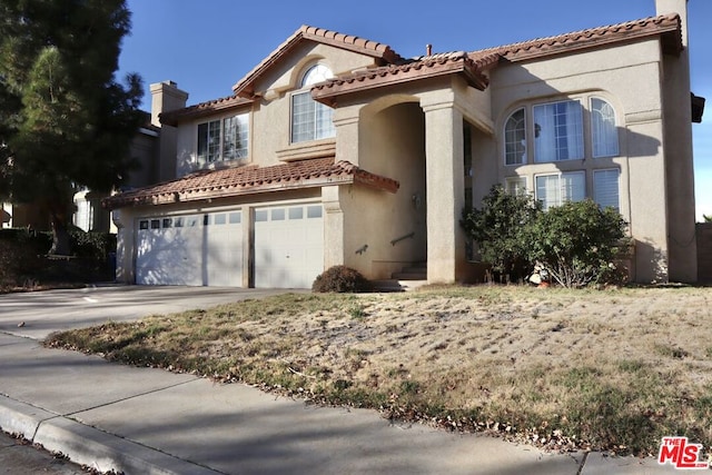 mediterranean / spanish-style house featuring a garage