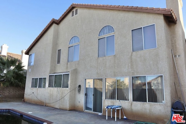 back of house featuring a patio area