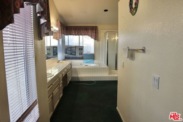 bathroom featuring independent shower and bath and vanity