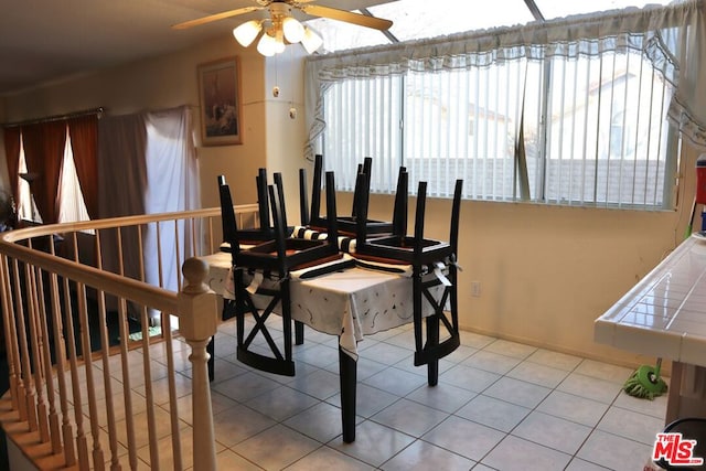 tiled dining area featuring ceiling fan