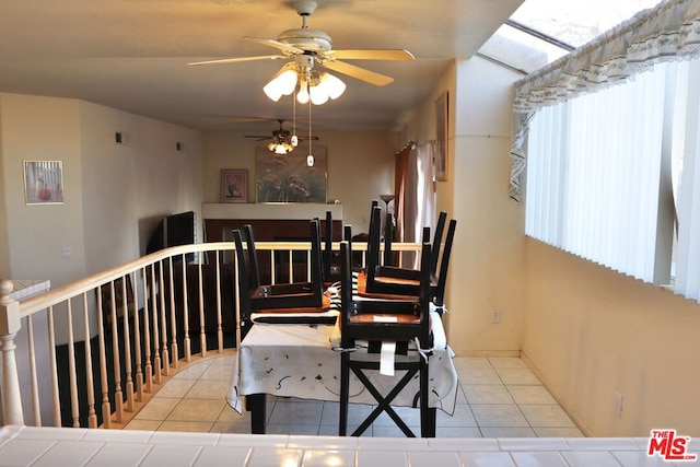 tiled dining area with ceiling fan