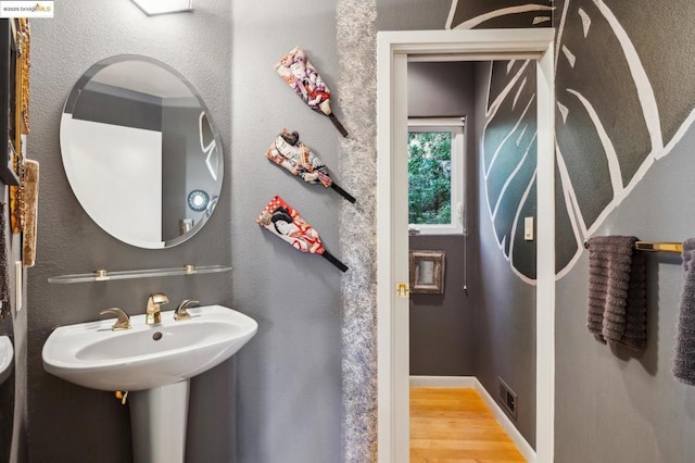 bathroom with wood-type flooring