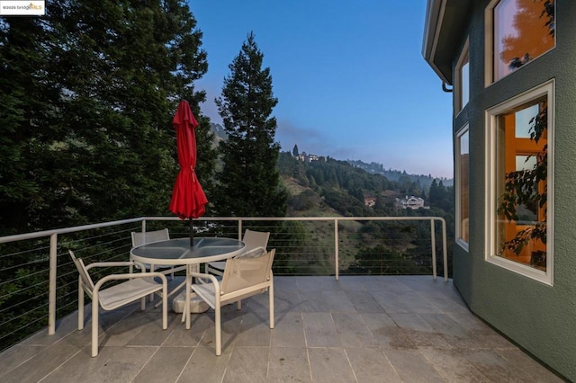 patio terrace at dusk with a balcony