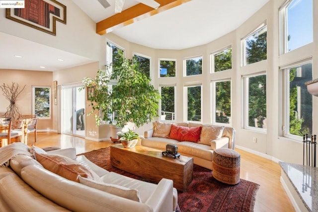 sunroom / solarium featuring beamed ceiling