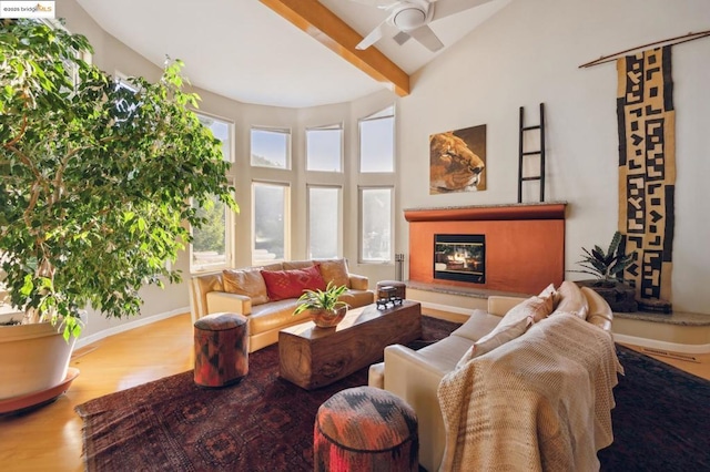 living room with wood-type flooring, ceiling fan, and vaulted ceiling with beams