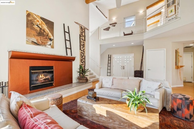 living room with a towering ceiling and wood-type flooring