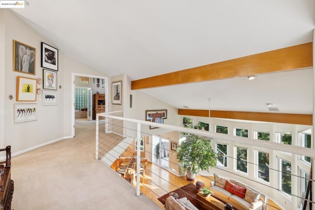 corridor featuring lofted ceiling with beams and light colored carpet