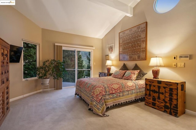 bedroom with lofted ceiling with beams, carpet floors, and access to exterior