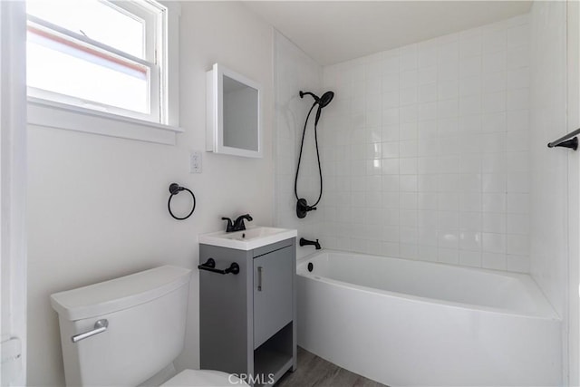 full bathroom featuring toilet, vanity, hardwood / wood-style flooring, and tiled shower / bath