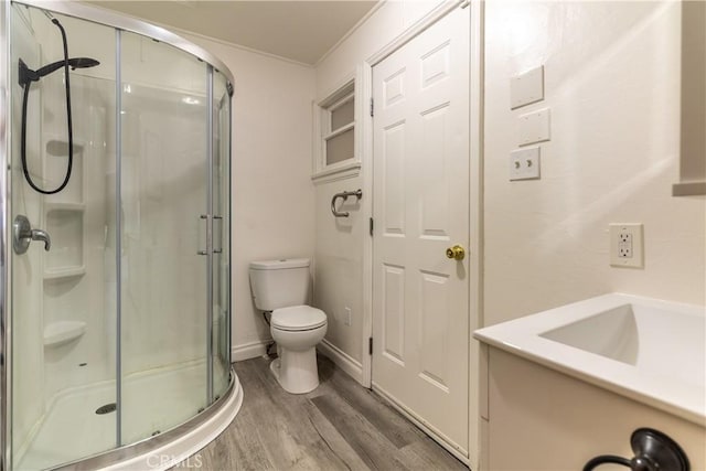 bathroom featuring hardwood / wood-style flooring, toilet, and walk in shower