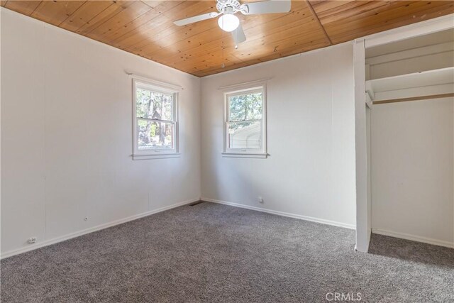 unfurnished bedroom featuring carpet, ceiling fan, and wood ceiling