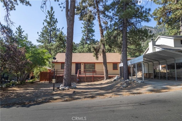 view of front of property featuring a deck and a carport