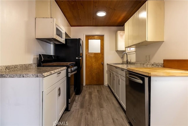 kitchen featuring sink, white cabinetry, light wood-type flooring, stainless steel appliances, and wooden ceiling