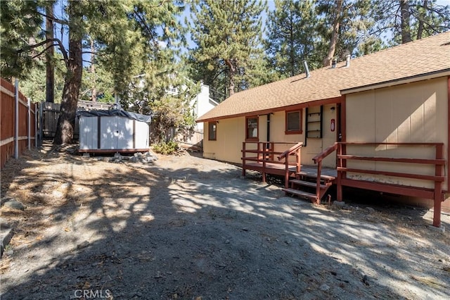 exterior space with a shed and a deck