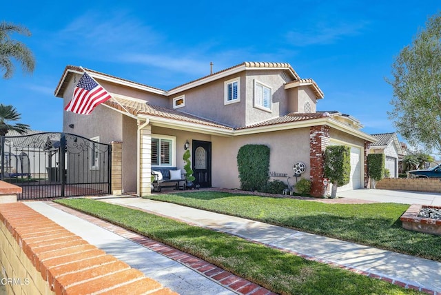 mediterranean / spanish-style house featuring a garage and a front lawn