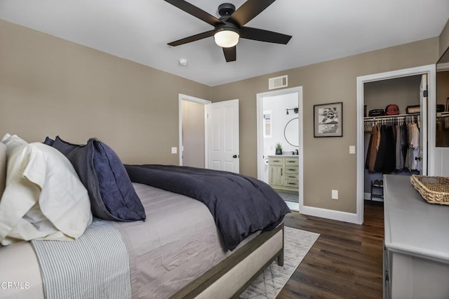 bedroom with ensuite bathroom, ceiling fan, dark hardwood / wood-style floors, a closet, and a walk in closet