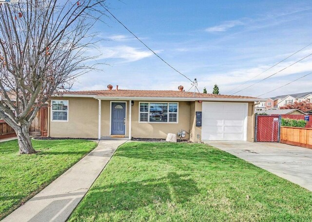 single story home featuring a front yard and a garage