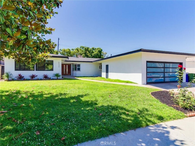 view of front of property with a front yard and a garage