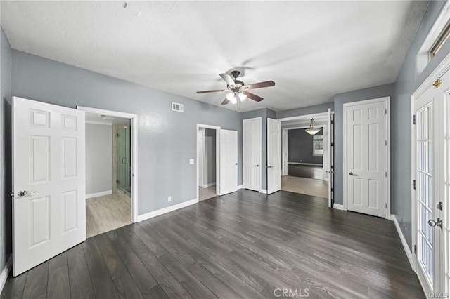 unfurnished bedroom with ceiling fan, dark hardwood / wood-style floors, and ensuite bath