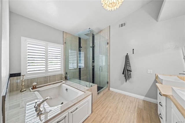 bathroom with separate shower and tub, vanity, and vaulted ceiling