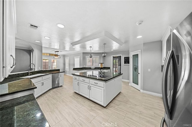 kitchen featuring pendant lighting, sink, stainless steel appliances, white cabinets, and french doors