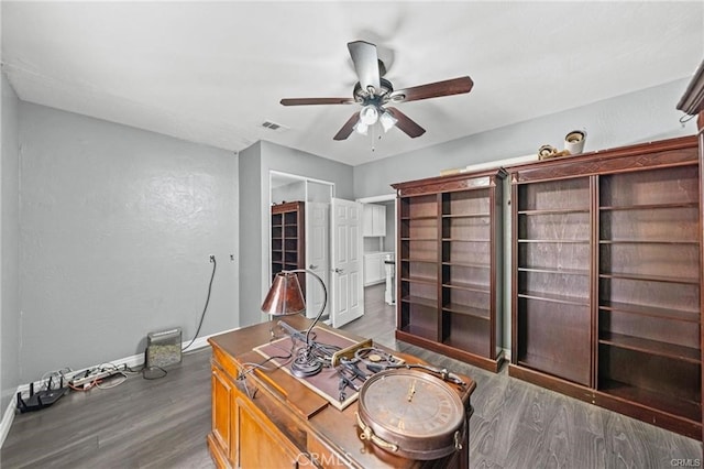 office space with ceiling fan and dark hardwood / wood-style flooring