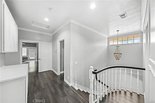 stairs with crown molding, wood-type flooring, and plenty of natural light