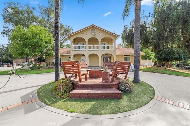 mediterranean / spanish-style house featuring a balcony