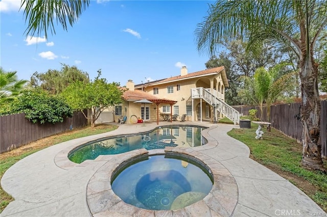 view of pool featuring central AC, a patio, and an in ground hot tub