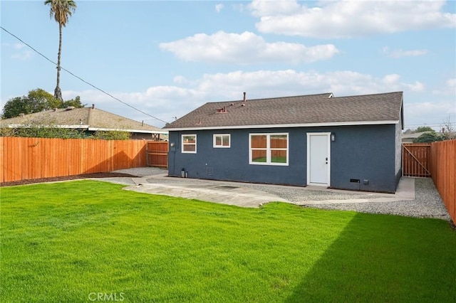 back of house with a patio area and a lawn