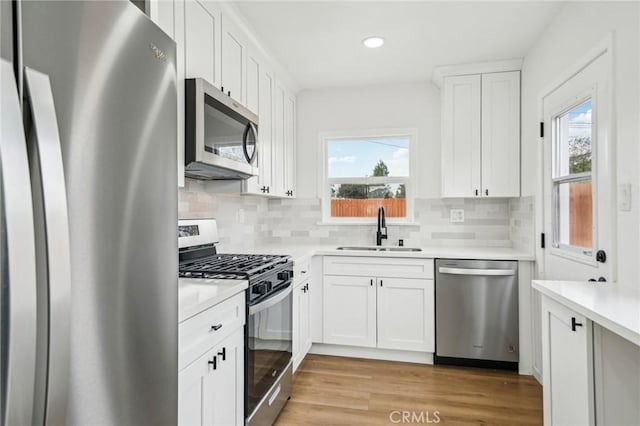 kitchen featuring sink, white cabinetry, and stainless steel appliances