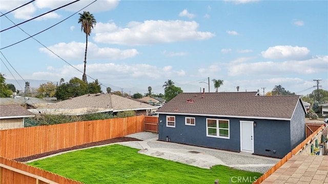 rear view of property with a yard and a patio