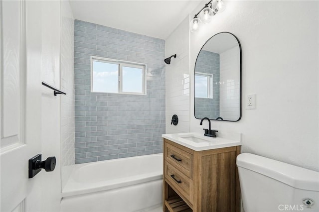 full bathroom with toilet, vanity, and tiled shower / bath combo