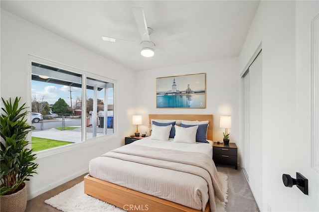 bedroom featuring ceiling fan, a closet, and carpet flooring